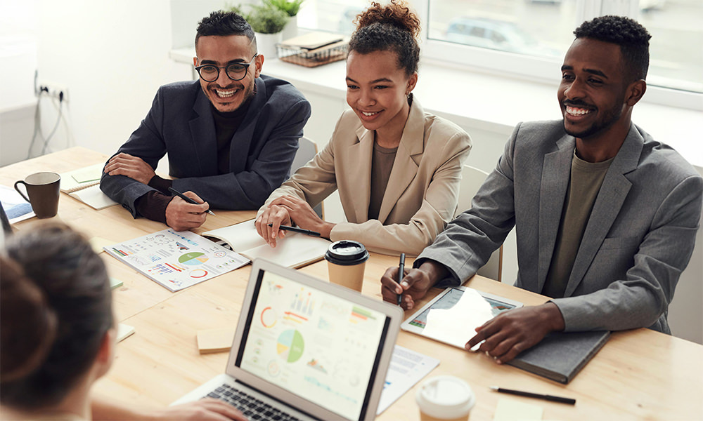 people sitting in a meeting smiling