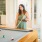 a woman smiling while playing pool